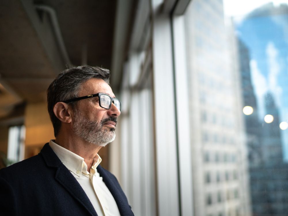 Mature businessman looking out the window.